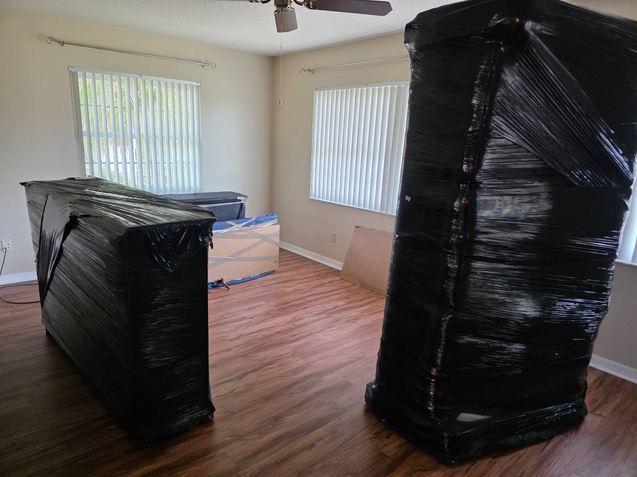 Living room furniture wrapped and staged mid-move