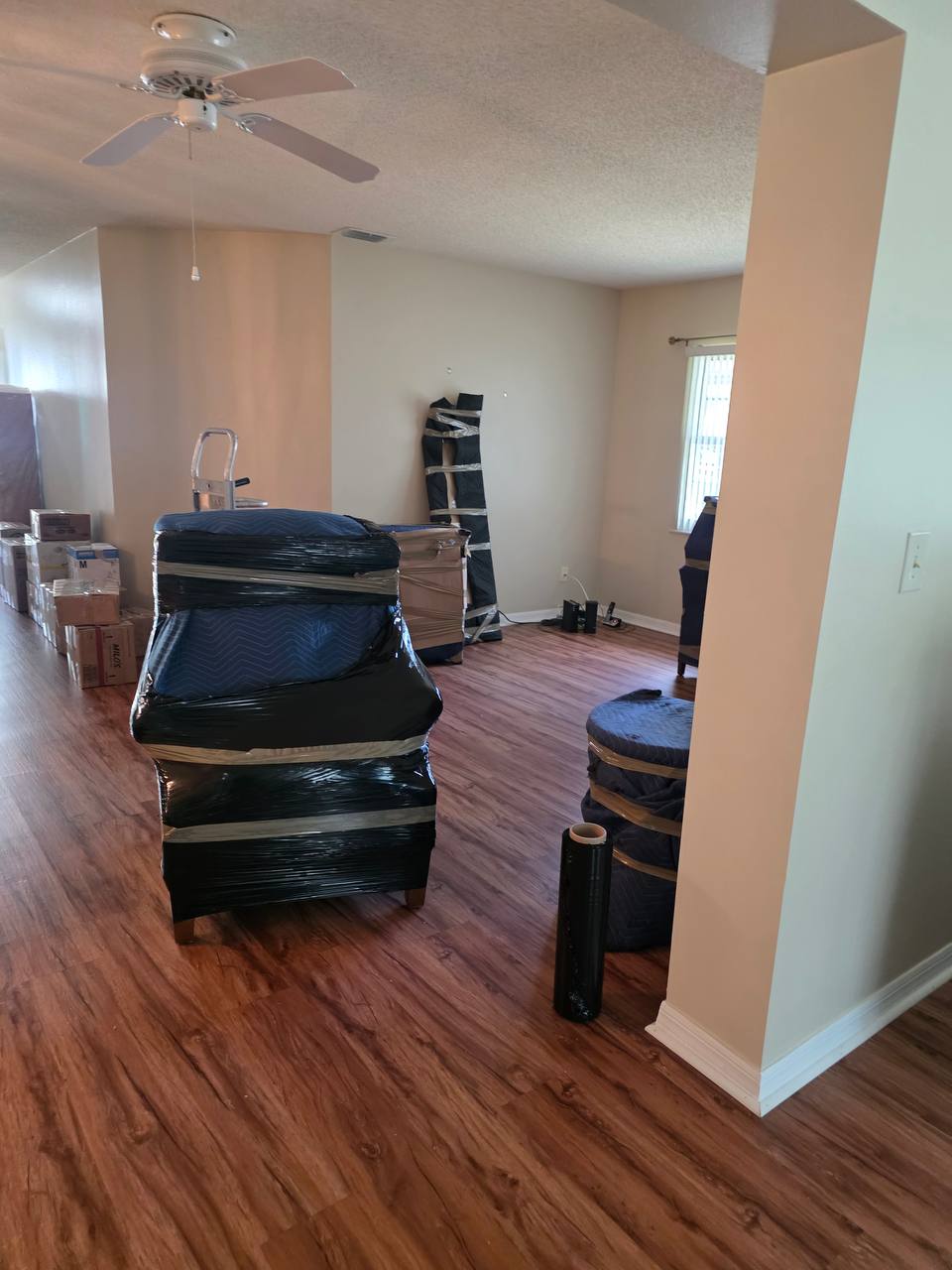 Apache Moving crew member packing a box inside a private jet cabin