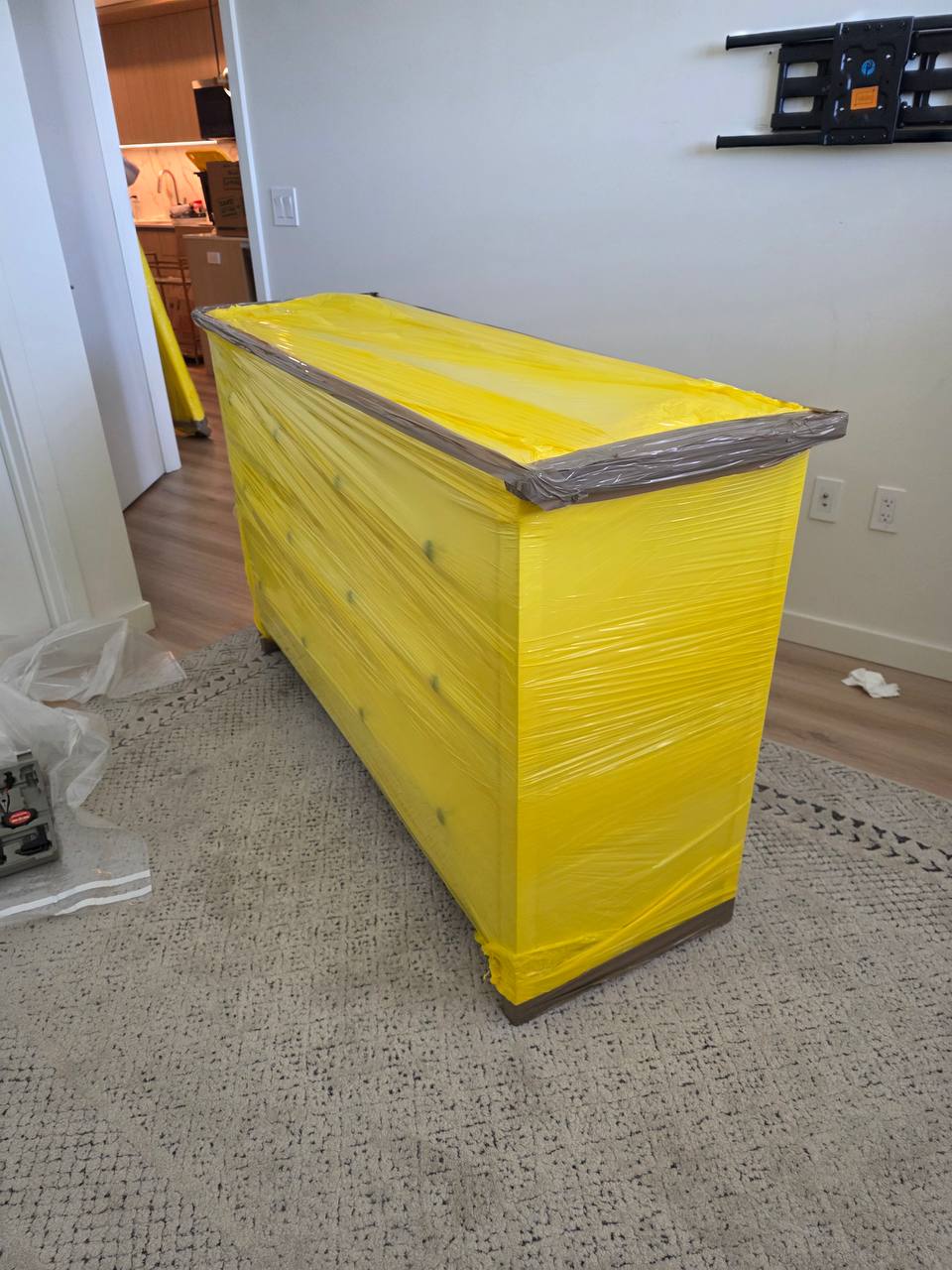 Shrink-wrapped bedroom dresser protected before a local move